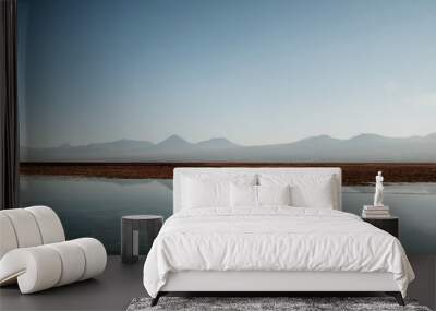 Quietly situated sea with a view of distant mountains on the horizon Wall mural