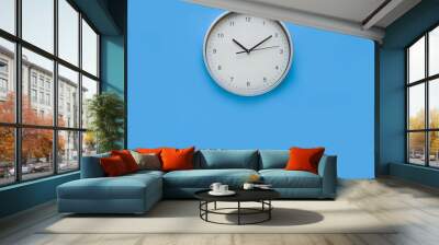 Wall clock on Blue wall. Copy Space concept Wall mural