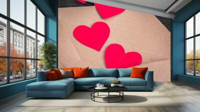 Brown envelope with red paper hearts on wood background Wall mural