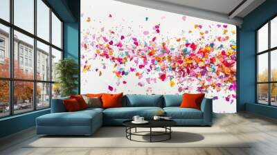 A studio photograph of colorful confetti against a white background. Wall mural