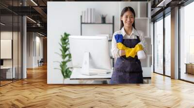 Asian young cleaning service woman worker clean table at home. Beautiful young girl housekeeper cleaner feel happy and wiping messy dirty counter for housekeeping housework or chores. Wall mural