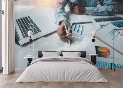 Business women sitting on a laptop and checking business graph documents, working in financial transactions, accounting Wall mural