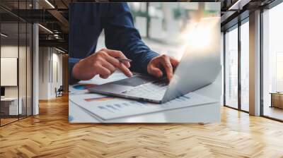 Financial market analyst,professional businessman working on new project with notebook computer while sitting at his office, flare light, blurred background Wall mural