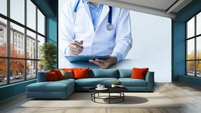 Online medical consultation doctor working on laptop computer in clinic office, healthcare, medical service, consultation or education, healthy lifestyle concept Wall mural