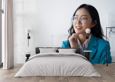 Portrait of young beautiful businesswoman working in her office room. Wall mural