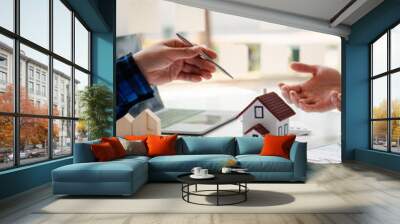 The real estate agent is explaining the house style to the clients who come to contact to see the house design and the purchase agreement, Mortgage loan approval home loan and insurance concept. Wall mural