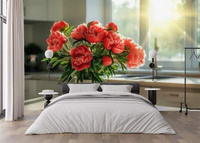 Bunch of bright red peony flower standing on modern table in light modern kitchen. The bright spring sun shining through the window Wall mural