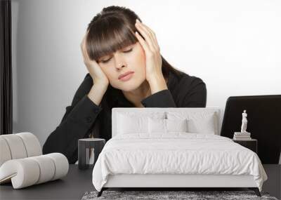 Exhausted woman at the work desk with closed eyes Wall mural