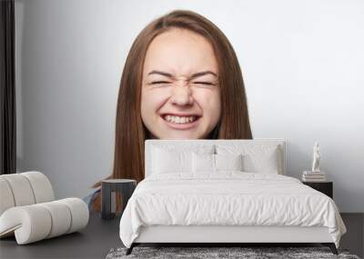 Happy emotional teen girl closing her eyes tight Wall mural