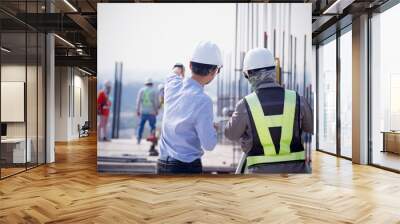 Engineer and surveyor Clear shop drawing and work together at site construction. Wall mural