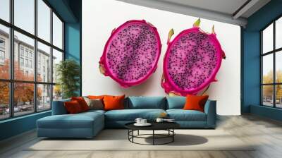 Two vibrant dragon fruit halves displayed on a plain white background, showcasing their pink flesh and black seeds. Wall mural