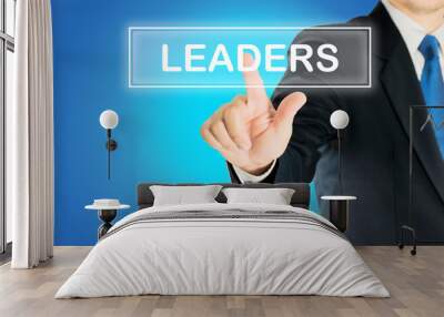 Business man is pushing LEADERS transparent button word over blue gradient background, business concept Wall mural