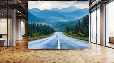 Endless road leading through a serene forest into the majestic mountains under a cloudy sky, inviting exploration and adventure. Wall mural