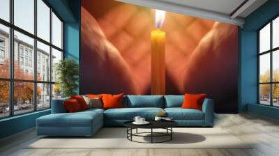 hands holding burning candle from wind Wall mural