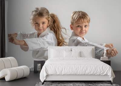 a 6 year old boy and girl making a dynamic karate pose, wearing a karate uniform, full body, white belt, on a white background Wall mural