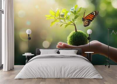 hand holding green earth with tree and butterfly in hand on blurred background, high resolution photography Wall mural