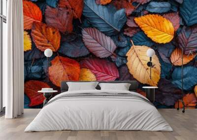 Vibrant autumn foliage, intricate textures of fallen leaves, rich colors spread across the ground, seasonal beauty captured from above Wall mural