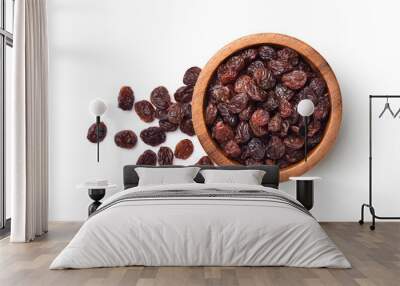 Flat lay of Raisins in wooden bowl isolated on white background. Wall mural