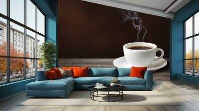 Hot coffee with coffee smoke on wooden table. Wall mural