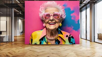 Portrait of adorable retired old woman wearing colorful fashionable clothes over pink background. Generative AI Wall mural