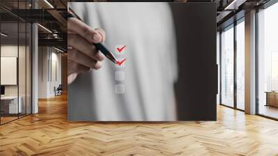 checklist concept, person using pen checking mark on checkboxes Wall mural