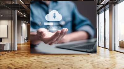 Download processing data concept. Downloading data from cloud storage. Person using laptop with downloading bar on virtual screen for download files. Wall mural