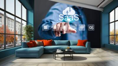 SaaS, software as a service concept. Businessman touching cloud SaaS icon on virtual screen. software services on cloud system. Internet and networking technology. Wall mural