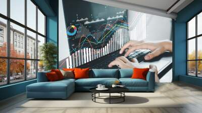 Businesswoman using laptop with financial,business analytics chart and graph interface idea for  business analytics,economic analysis,planning. Wall mural