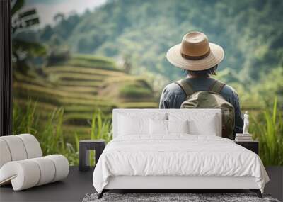 Person wearing a hat and backpack in tropical rice terraces selective focus, emphasis on hat, exploration theme, ethereal, Overlay, green scenery backdrop Wall mural