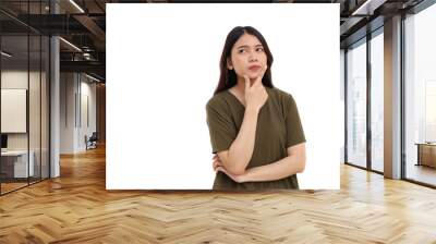 Portrait of beautiful young asian woman standing while thinking something. Isolated on white background Wall mural