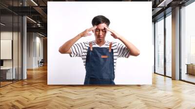 Sad asian young man in apron with worried stressed face expression. Obsessive compulsive, adhd, anxiety disorders Wall mural