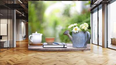 White cup and white pot and flowers in rustic watering pot on wooden table Wall mural