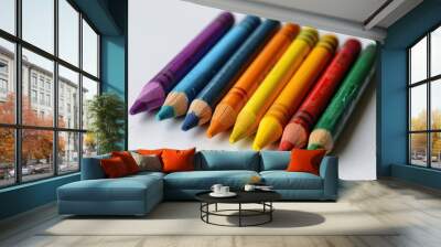 Vibrant Collection of Crayons and Art Pad on Clean White Background for Creative Inspiration Wall mural