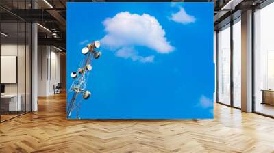 Antenna with many receiver dishes and sky and clouds background. Wall mural