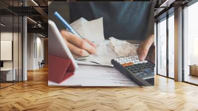 man using calculator for  calculate expenses accounts Wall mural