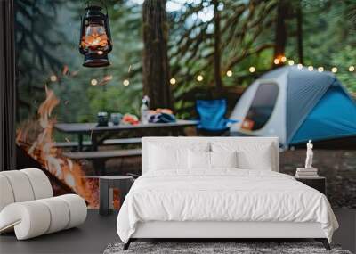 A cozy campfire scene with tents and outdoor cooking equipment Wall mural