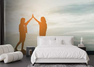 cheerful friend doing high five against the sunset background Wall mural