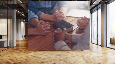 Christians and Bible study concept. Group of discipleship Studying the Word Of God in church and christians holding each others hand praying together Wall mural