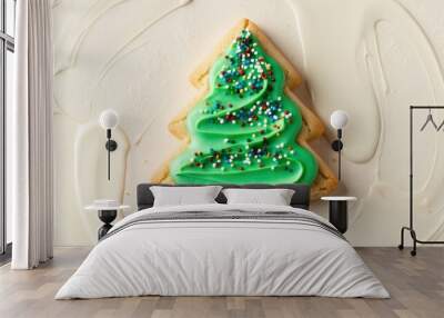 A Christmas cookie shaped like a tree, frosted in green icing and colorful sprinkles. Wall mural