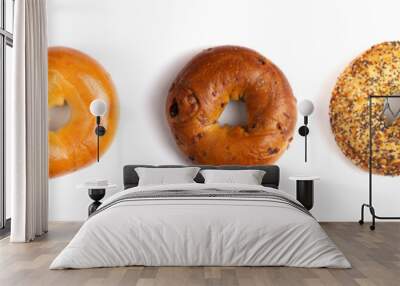 a row of five different types of bagels isolated on a white background Wall mural