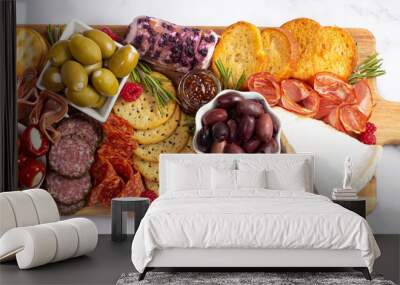 A Savoury Charcuterie Board Covered in Meats Olives Peppers Berries and Cheese Wall mural