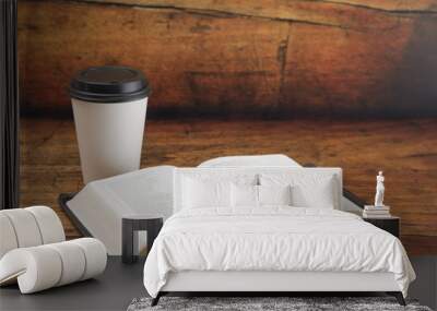 Bible and a Cup of Coffee in a Disposable Paper Cup on a Wooden Table Wall mural