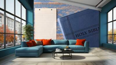 Holy Bible on a Rustic Wooden Table with a Blank Piece of Antique Paper for Adding Text Wall mural