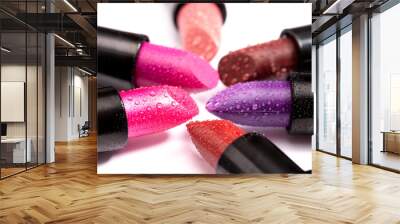 Multiple Tubes of Different Colored Lipsticks on a White Background Wall mural