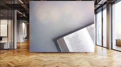 Single Bible Open on a Gray Background Wall mural