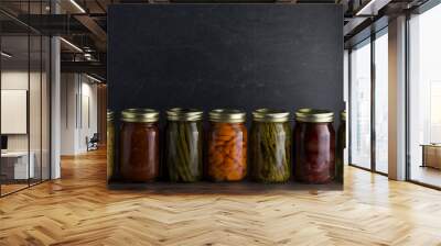 Various Types of Canned Vegetables on a Wooden Table in a Dark Environment Wall mural