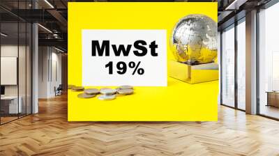 Text MWST . Globe and wooden cubes on a YELLOW background. The concept of world business, marketing, finance. Wall mural