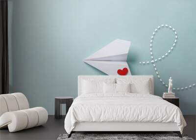 paper love airplane on color background..the concept of a love message. valentine's day. declare lov Wall mural