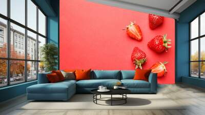 Ripe juicy strawberries on a red background. pattern. Creative summer background composition with strawberry. Minimal fruit concept. Wall mural