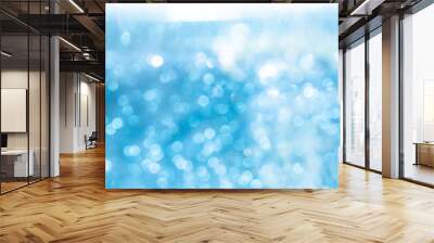 Abstract blurred blue and white bokeh lights background with soft gradient colors, creating a dreamy and serene effect, perfect for festive and decorative use. Wall mural